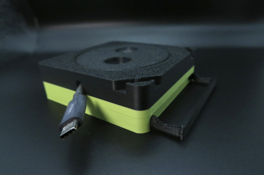 CORDGANIZER phone stand and cable organizer - close-up studio shot showing USB-C cable routing