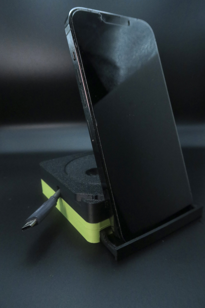 CORDGANIZER phone stand and cable organizer - lifestyle scene, angled view with phone docked